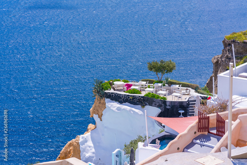 Table and chairs on a tarrace with view of Aegean Sea in Oia. Santorini, Cyclades, Greece photo