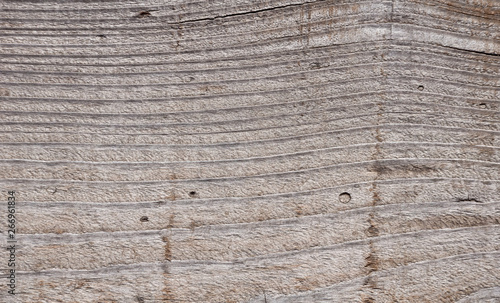 Texture photo of grey, worn, shabby, old and cracked wood which was exposed to weather and sun for years. Ideal as a background