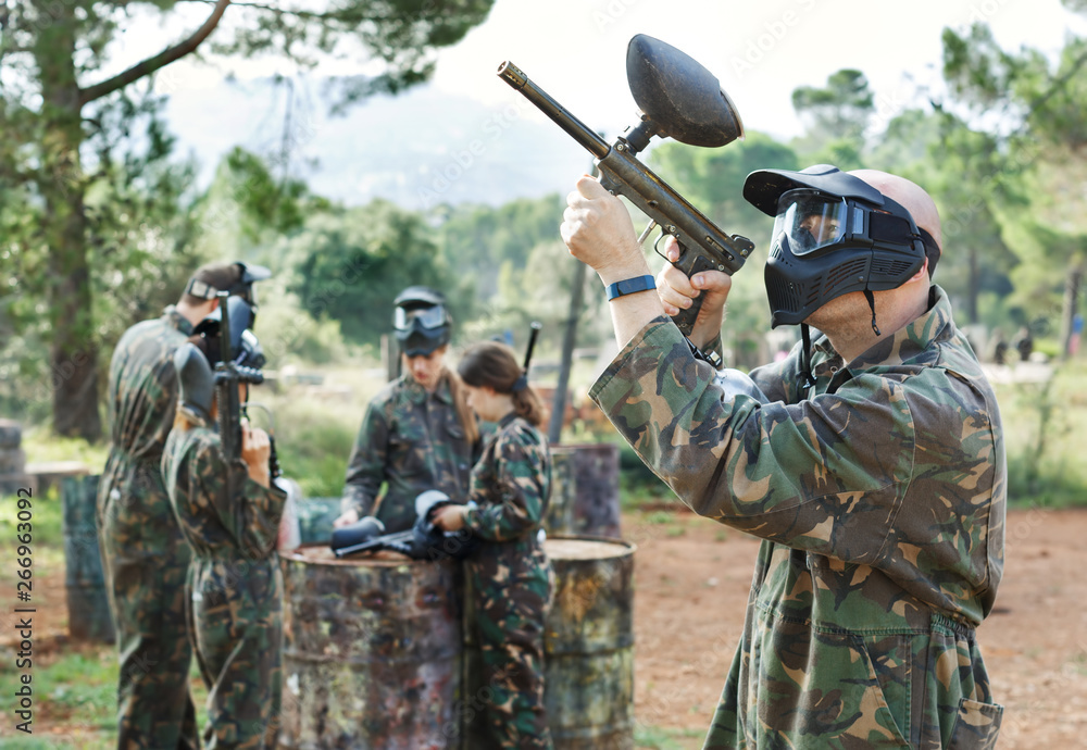 Fototapeta premium Paintball player in camouflage with gun