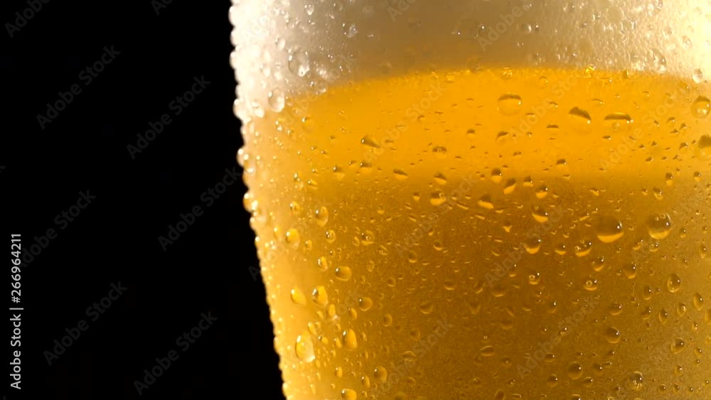 Close up of cold beer with drops and bubbles. Close up of cold beer with drops and bubbles.