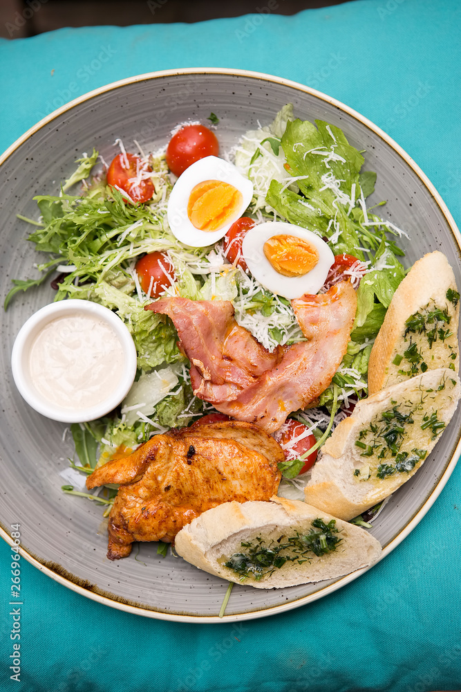 Chicken ceasar salad. Chicken, pancetta, eggs, tomatoes with garlic bread with caesar sauce. Chicken ceasar salad. Chicken, pancetta, eggs, tomatoes with garlic bread with caesar sauce.