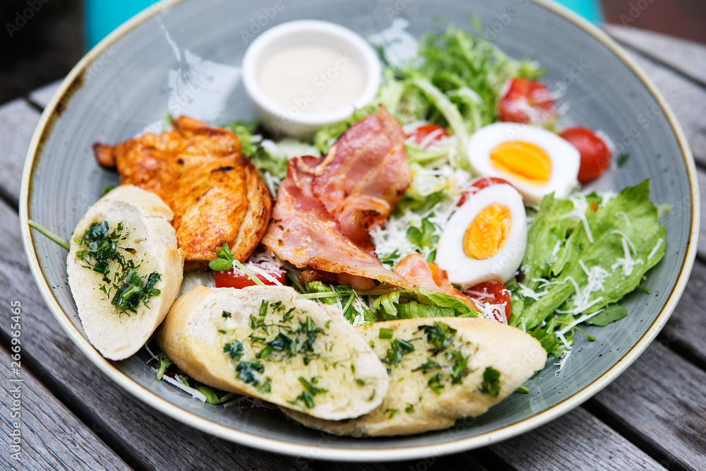Chicken ceasar salad. Chicken, pancetta, eggs, tomatoes with garlic bread with caesar sauce. Chicken ceasar salad. Chicken, pancetta, eggs, tomatoes with garlic bread with caesar sauce.