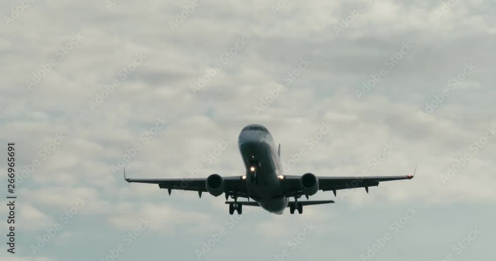 Cinematic shot of a passenger jet airplane about to land. 4K telephoto shot. Cinematic shot of a passenger jet airplane about to land. 4K telephoto shot.