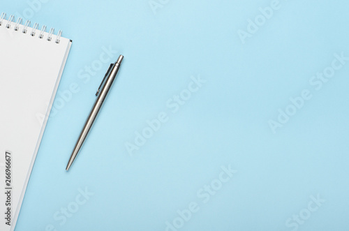 Wallpaper Mural White notepad with metal pen on a blue background. Office, copy space, mock up, template, top view, flat lay. Torontodigital.ca