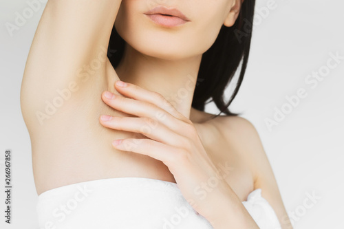 concept of skin care and cosmetology. young thin woman takes care of the skin of the body, touches the skin on the neck and shoulders, after moisturizing and rejuvenation procedures and hair removal