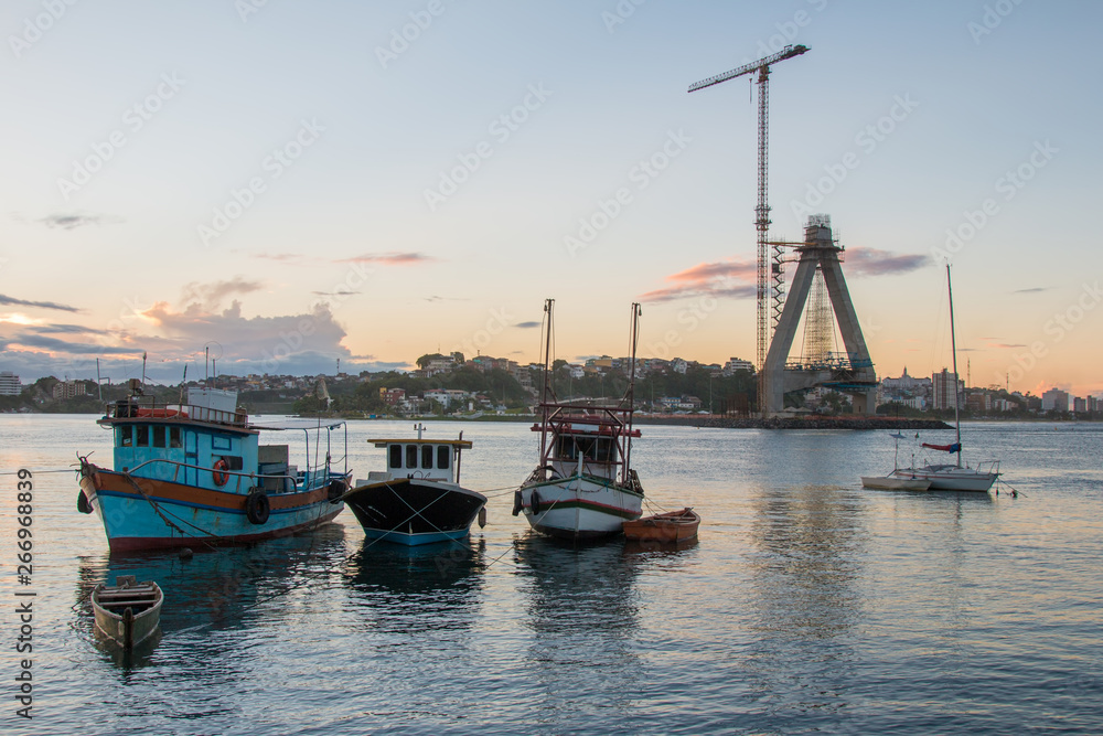 Landscape with boats in the water and bridge construction in the background