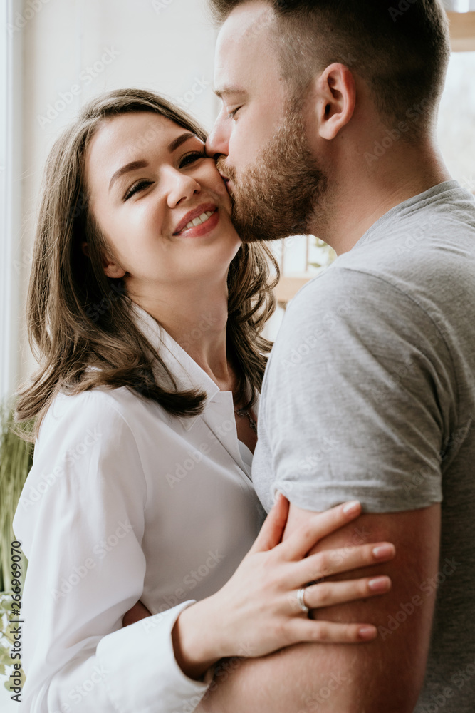 Romantic young couple cooking together in the kitchen,having a great time together. Romantic young couple cooking together in the kitchen,having a great time together.
