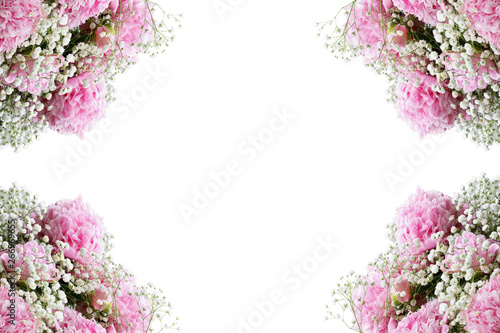 Flower composition. Frame of pink flowering bouquets of Peonies and Baby's Breath flowers over a white background with free space for your text. 