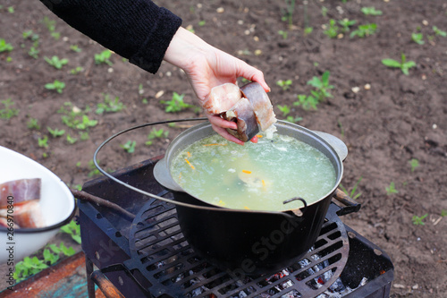 Сooking fish soup on the fire