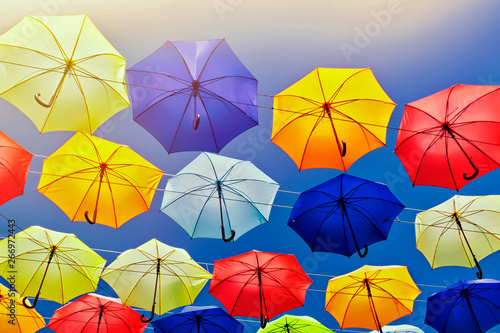 Colorful umbrellas on the sky background.