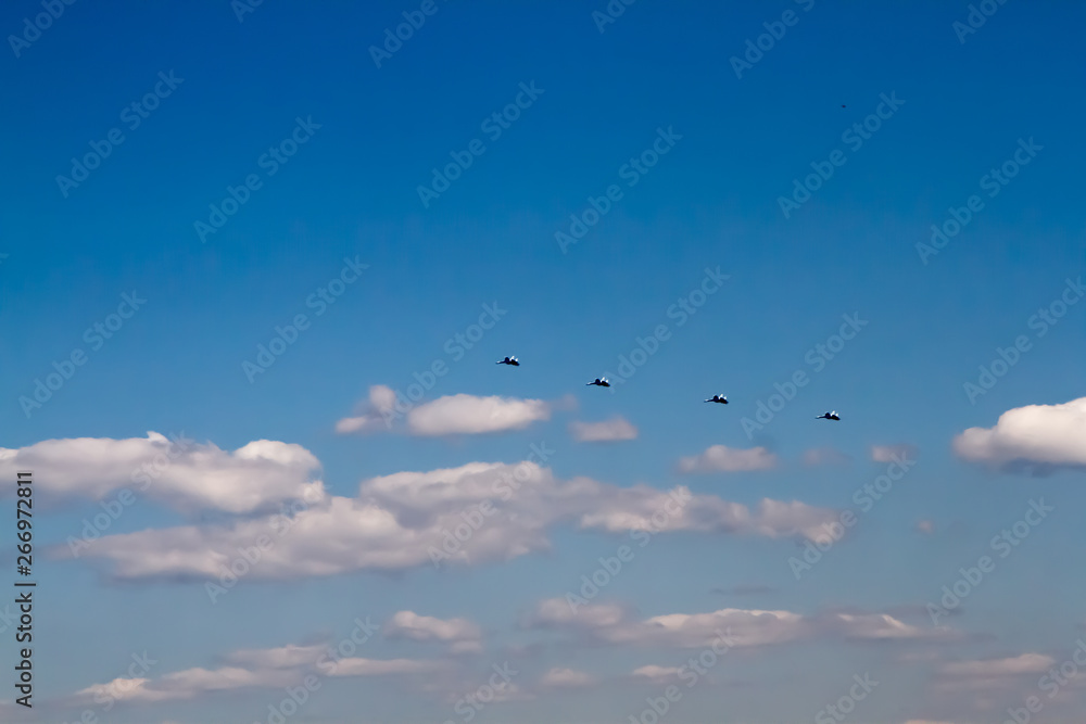 Military aircraft against the blue sky. Sunny day. Aircraft. Fighters