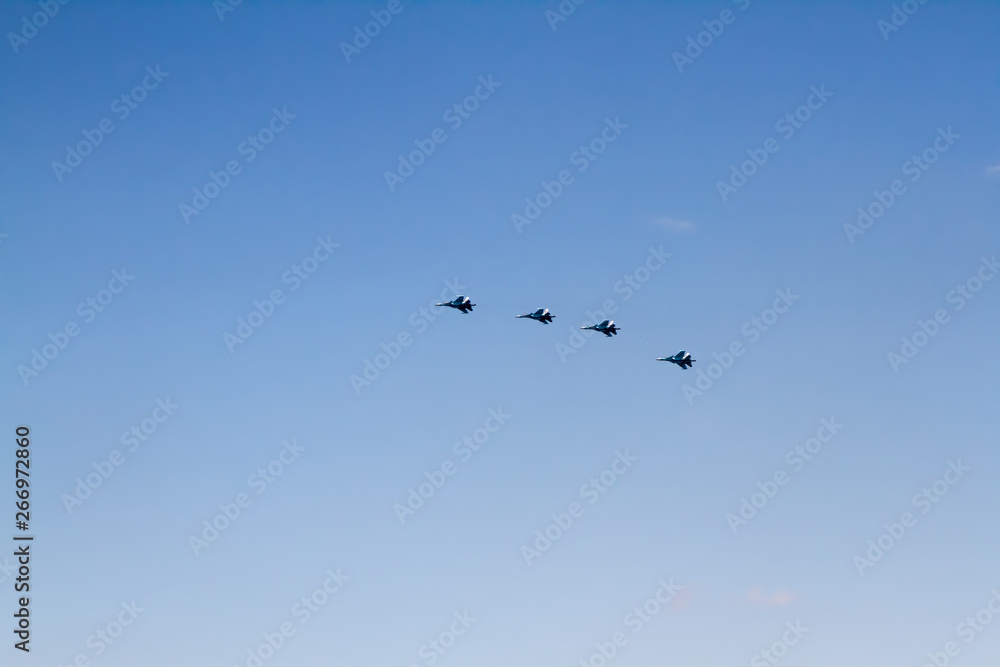 Military aircraft against the blue sky. Sunny day. Aircraft. Fighters