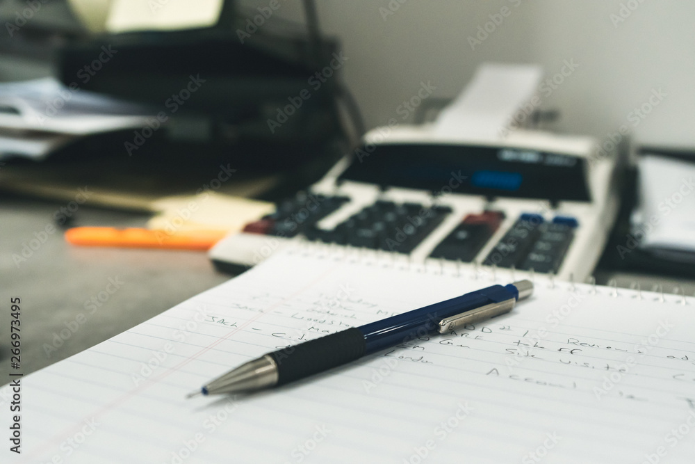 pen and calculator on paper pen and calculator on paper