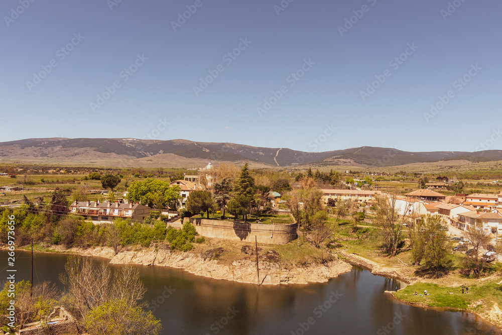 View of Lozoya river and Buitrago de Lozoya village. Sierra of Guadarrama. Madrid. Spain.