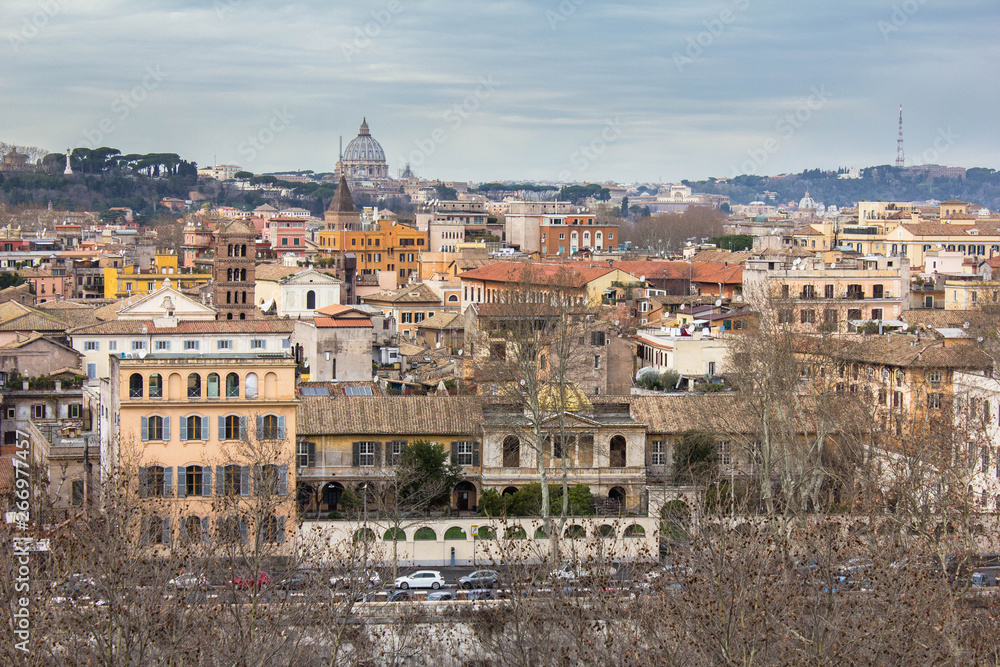 Residential buildings and facades, italian architecture, view from the observation deck on the houses with windows with shutters, streets, roadway. View from above in the park in Rome, Italy.