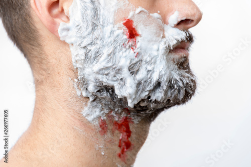 Shaving wounded, blood on man face