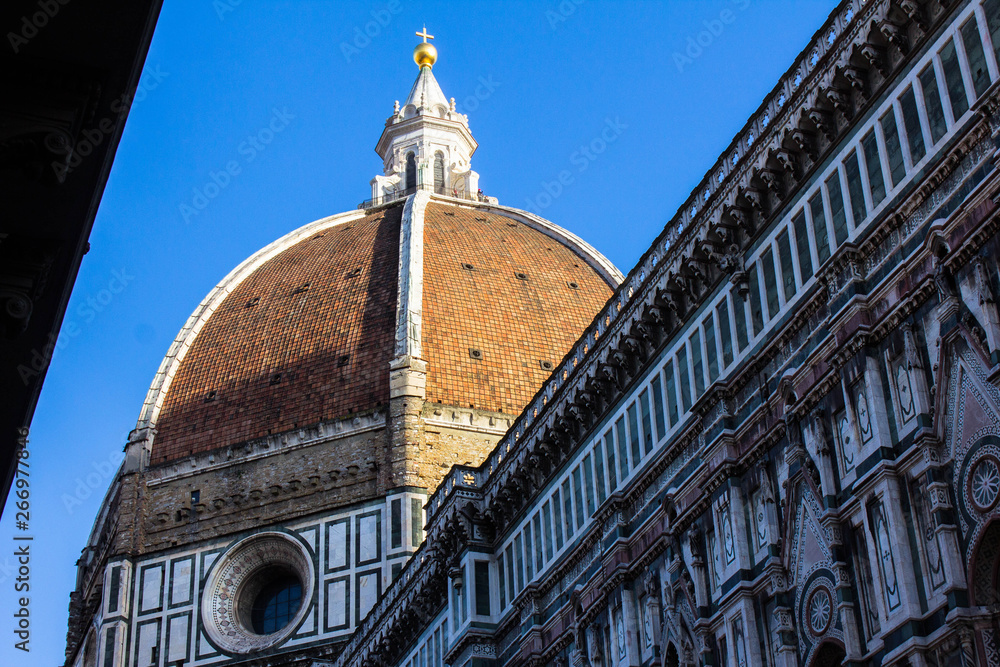 The dome of Florence Cathedral, Cattedrale di Santa Maria del Fiore. The main cathedral of Florence roof with blue sky above it. Italy, architecture, awesome church.