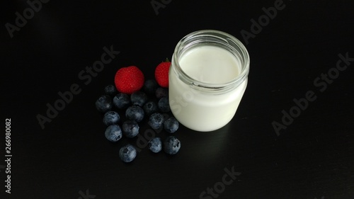 White Yogurt with Berries on a black tabletop