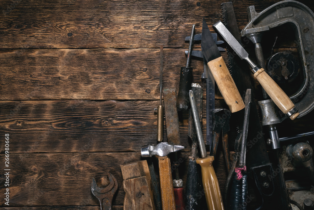 Various old construction tools on a wooden workbench flat lay background with copy space. Carpenter table. Woodwork. Various old construction tools on a wooden workbench flat lay background with copy space. Carpenter table. Woodwork.