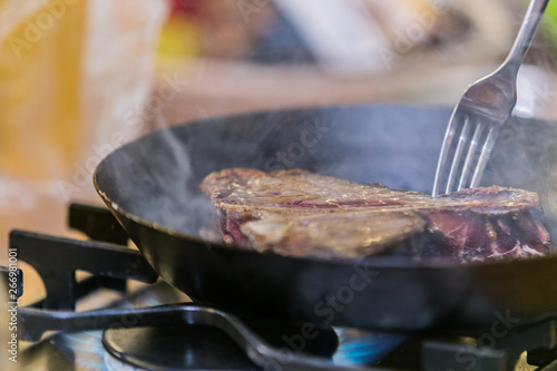 Grilling steak on grill pan. Beefsteak cooking on a kitchen. Fresh, delicious meat