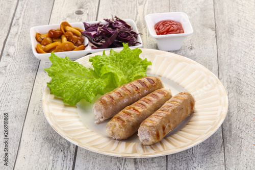 Grilled sausages served mushrooms and cabbage