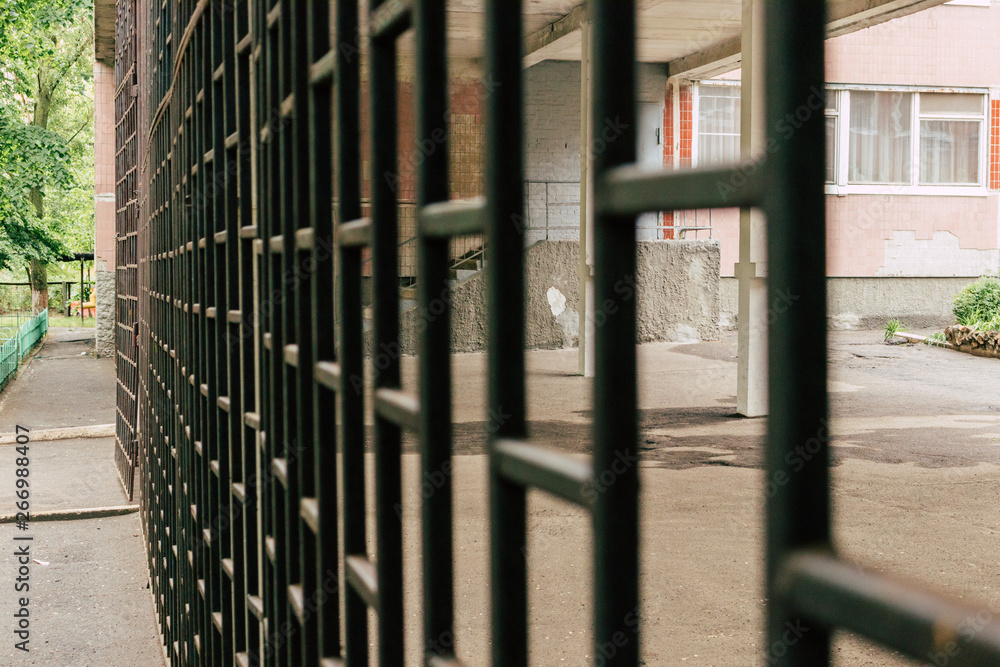 Government school building behind black bars Government school building behind black bars