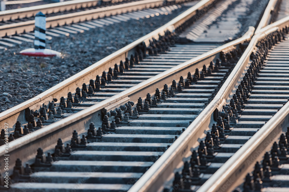 Fototapeta premium View of the rails, concrete sleepers and mound of crushed stone. The railroad tracks.