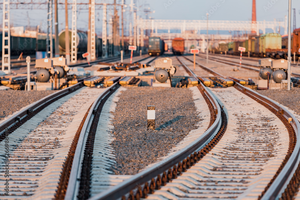 Obraz premium View of the rails, concrete sleepers and mound of crushed stone. The railroad tracks.