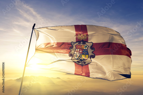 Huesca province of Spain flag waving on the top sunrise mist fog