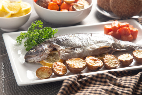 Whole Baked Rainbow Trout on a Table Set for Dinner