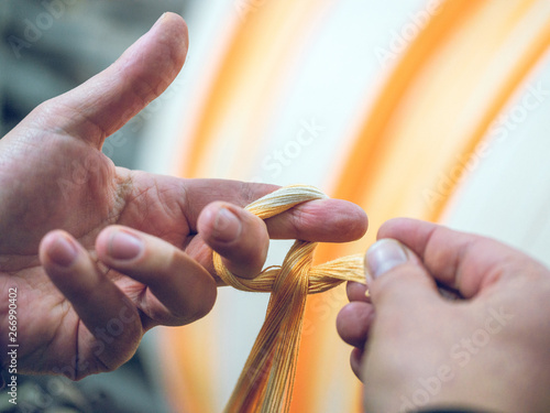 Crop person holding threads on loom photo