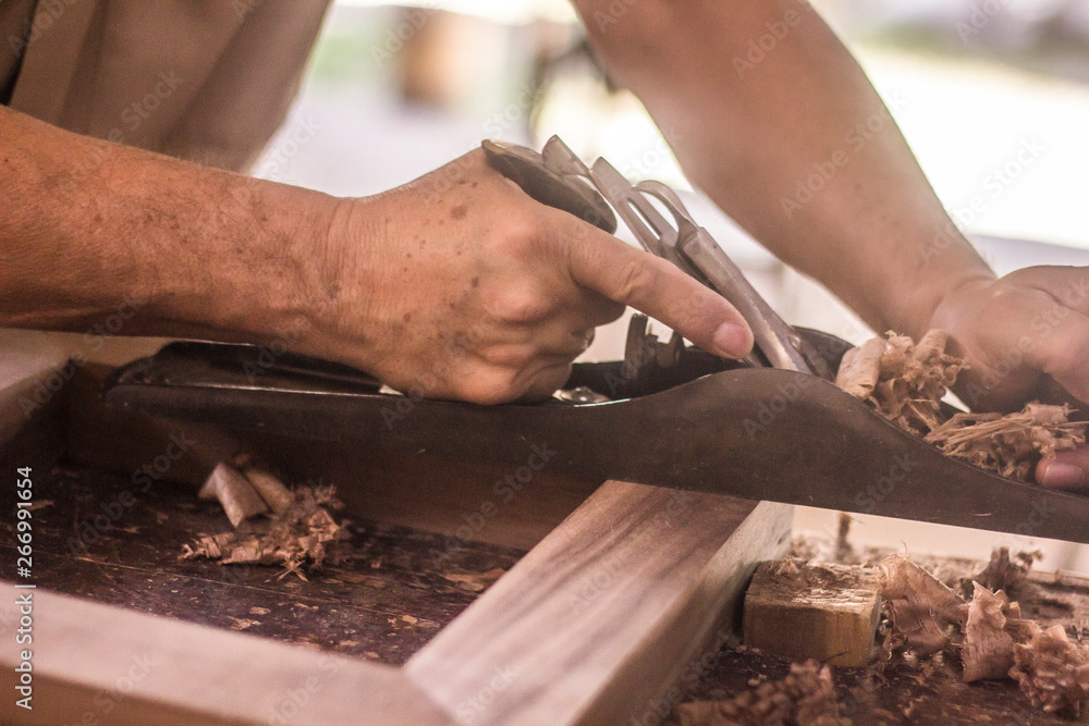 carpenter cutting plank with saw carpenter cutting plank with saw