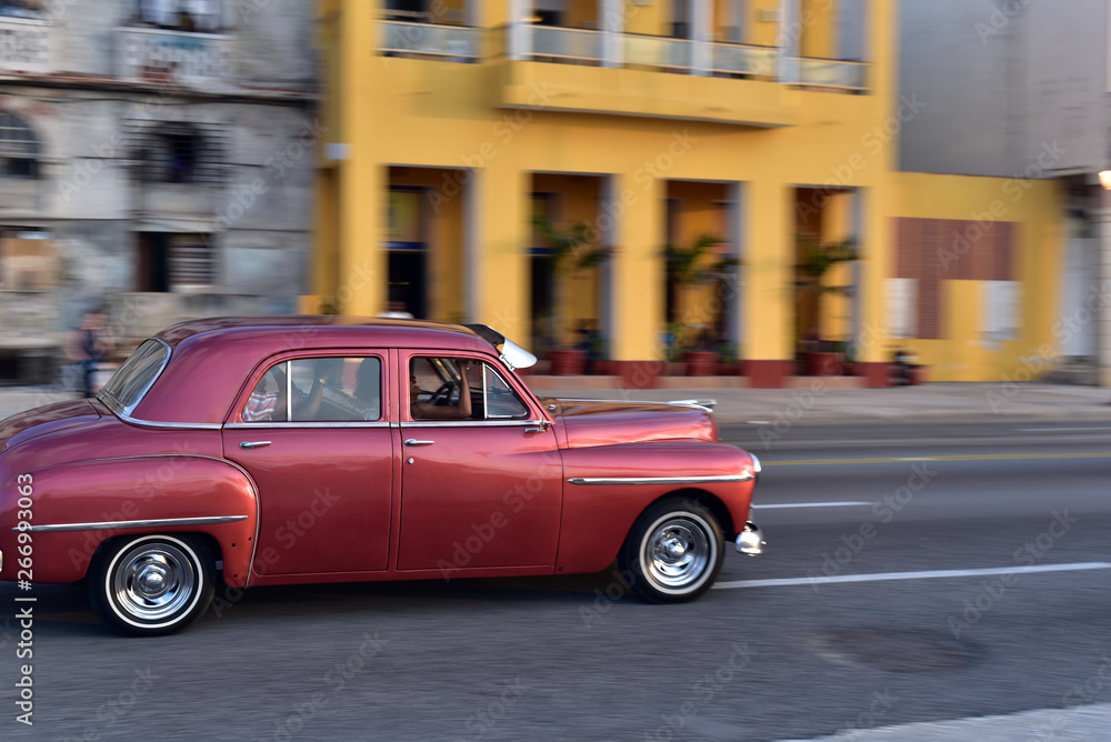 Classic american car speeding along the road at the El Malecon, Havana, Cuba