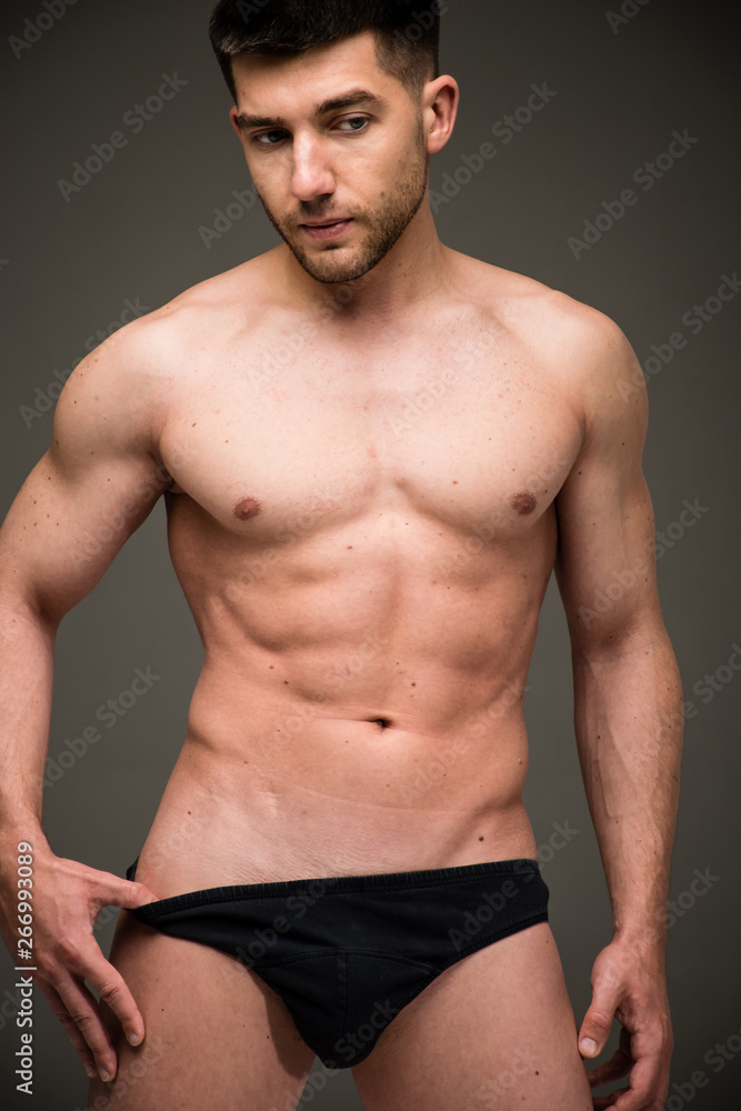 Handsome young man posing in black underwear (studio photoshoot)