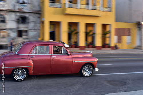 Classic american car speeding along the road at the El Malecon, Havana, Cuba