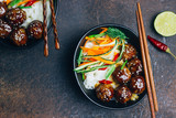 Meatballs with teriyaki souce, rice noodle, vegetables and sesame seeds