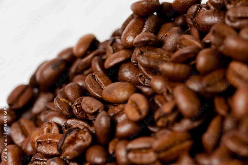 Freshly ground coffee beans roasted with fruits of coffee plant, on white background. Freshly ground coffee beans roasted with fruits of coffee plant, on white background.