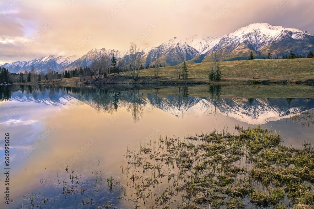 Springtime Mountain Landscape and Dramatic Sunset Colors at Quarry Lake above City of Canmore in Alberta Foothills of Canadian Rockies near Banff National Park