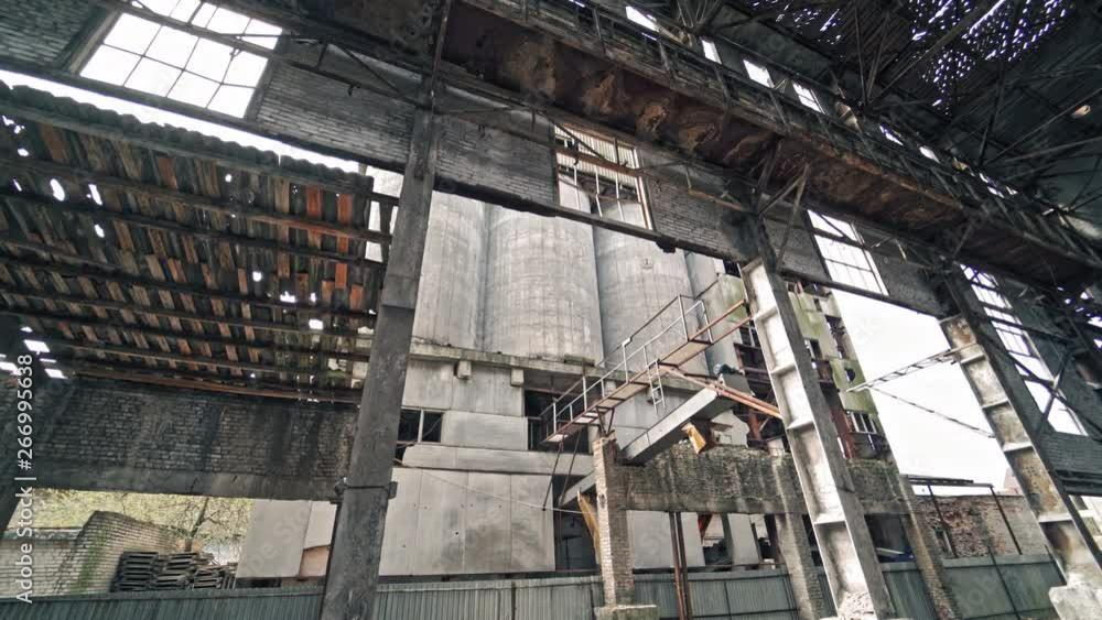 Ruins of an old factory. Interior of an abandoned derelict industrial structure.