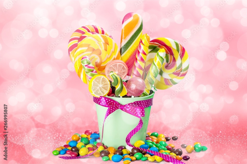 Colorful candies in bucket isolated on white Colorful candies in bucket isolated on white