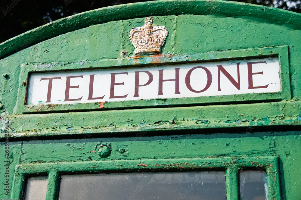 Telephone box which has been painted green, traditionally done in Ireland.