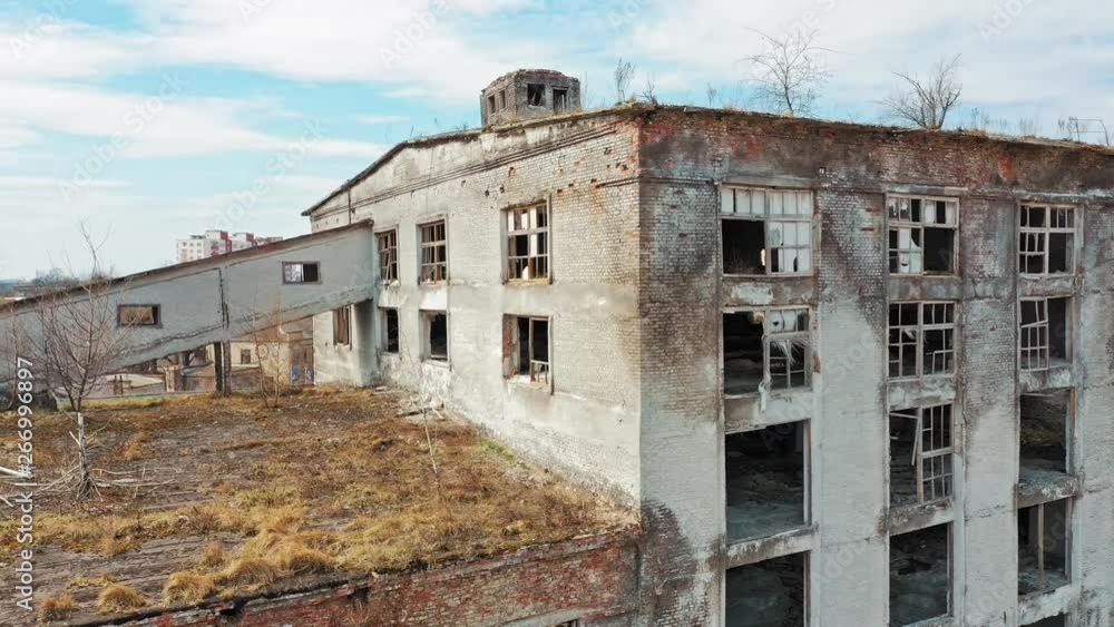 Aerial view of an old factory ruin and broken windows. Old industrial building for demolition. Aerial view of an old factory ruin and broken windows. Old industrial building for demolition.