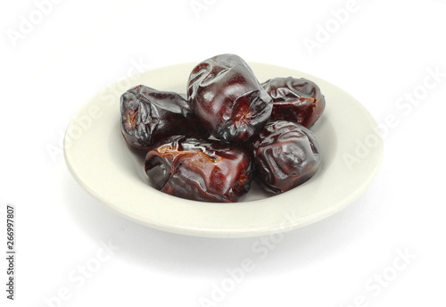 Dried dates over white background. Heap of dried dates isolated on white background.