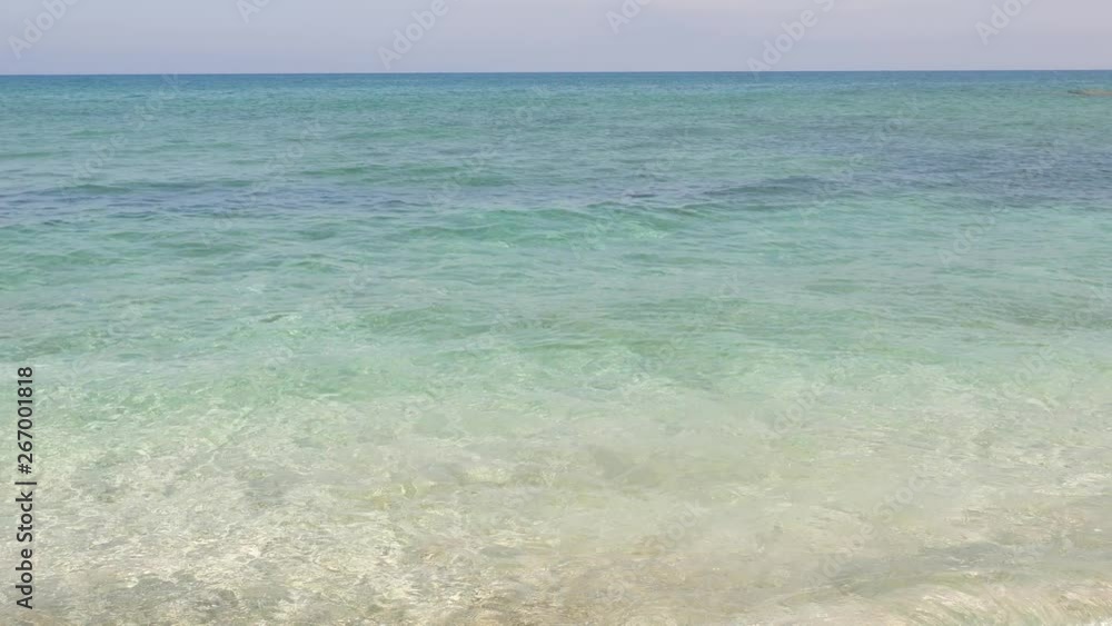 Crystal clear sea waters, sandy bottom seen through, neat shades and colours of Aegean Sea at North Crete Island. Beautiful pure nature shot Crystal clear sea waters, sandy bottom seen through, neat shades and colours of Aegean Sea at North Crete Island. Beautiful pure nature shot