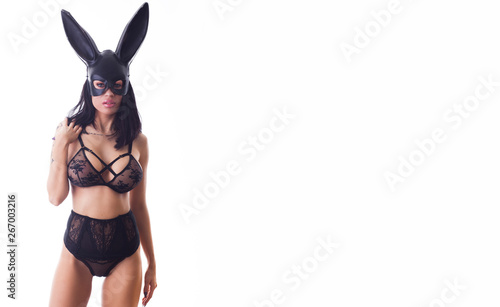 Sexy woman in black bikini in rabbit mask isolated on white background.