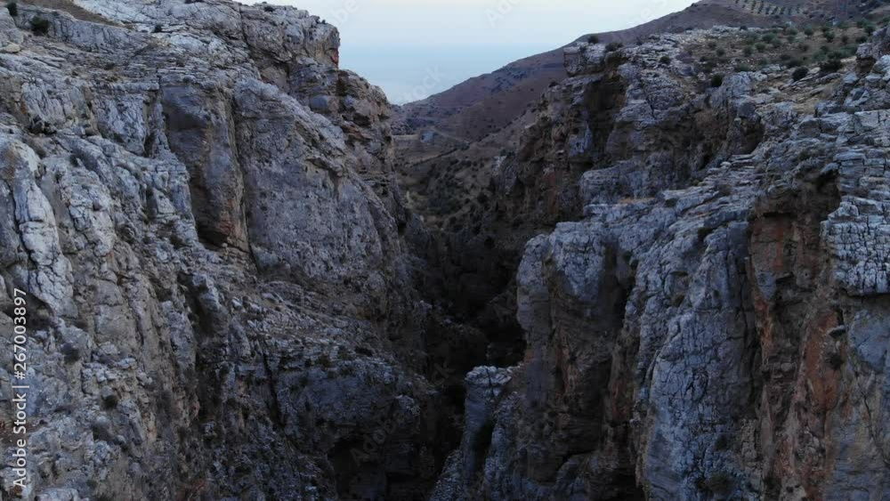 Rough stony cliffs of deep gorge, Portela canyon aerial shot at dusk. Rocky sides of nature formation, arid landscape at summer season Rough stony cliffs of deep gorge, Portela canyon aerial shot at dusk. Rocky sides of nature formation, arid landscape at summer season