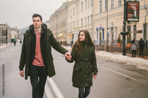 young couple, heterosexual boy and girl of Caucasian nationality, loving couple, walk around the center of country of European city in the middle of road on divided lane. Love and Romance Theme