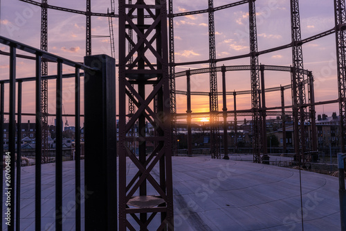 Silhouette of an empty gas storage cylinders against the dusk sunset sky in  London.