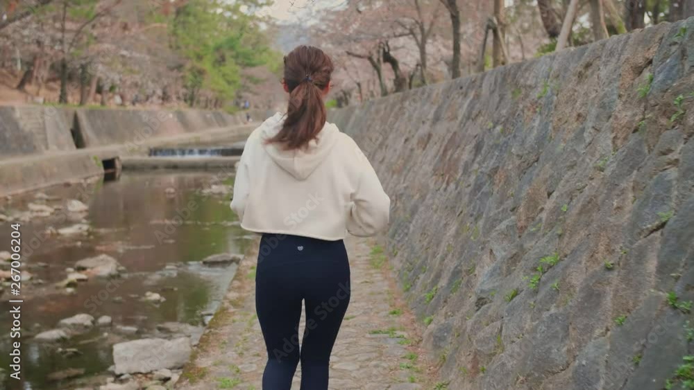 Japanese beautiful women running training on river cherry blossoms Japanese beautiful women running training on river cherry blossoms
