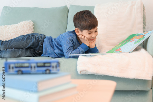 Cute little boy reading boo...